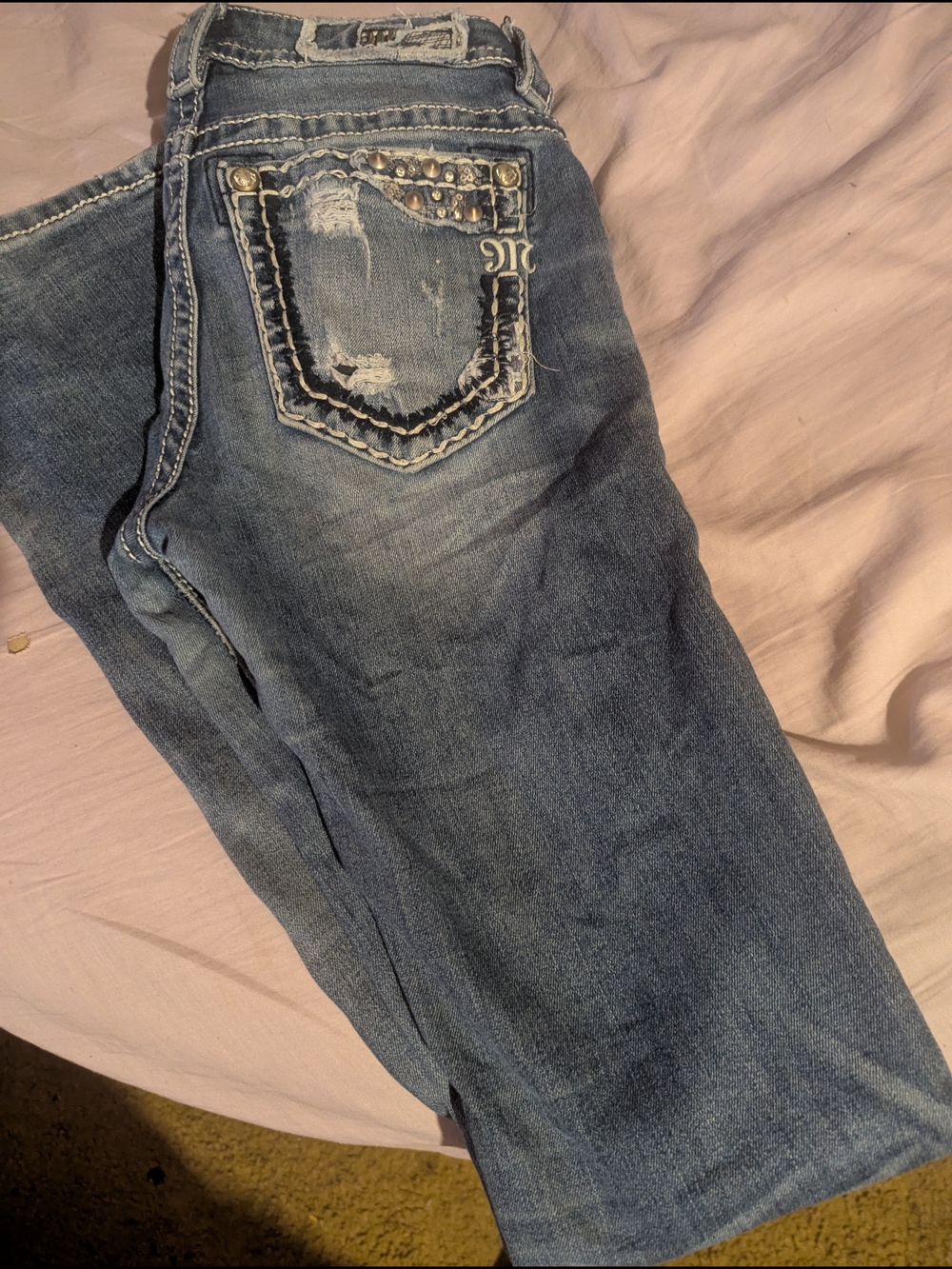 Women’s Light Blue Distressed Jeans with Embellished Back Pocket